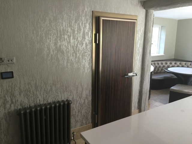 Walk in fridge in home with brown door